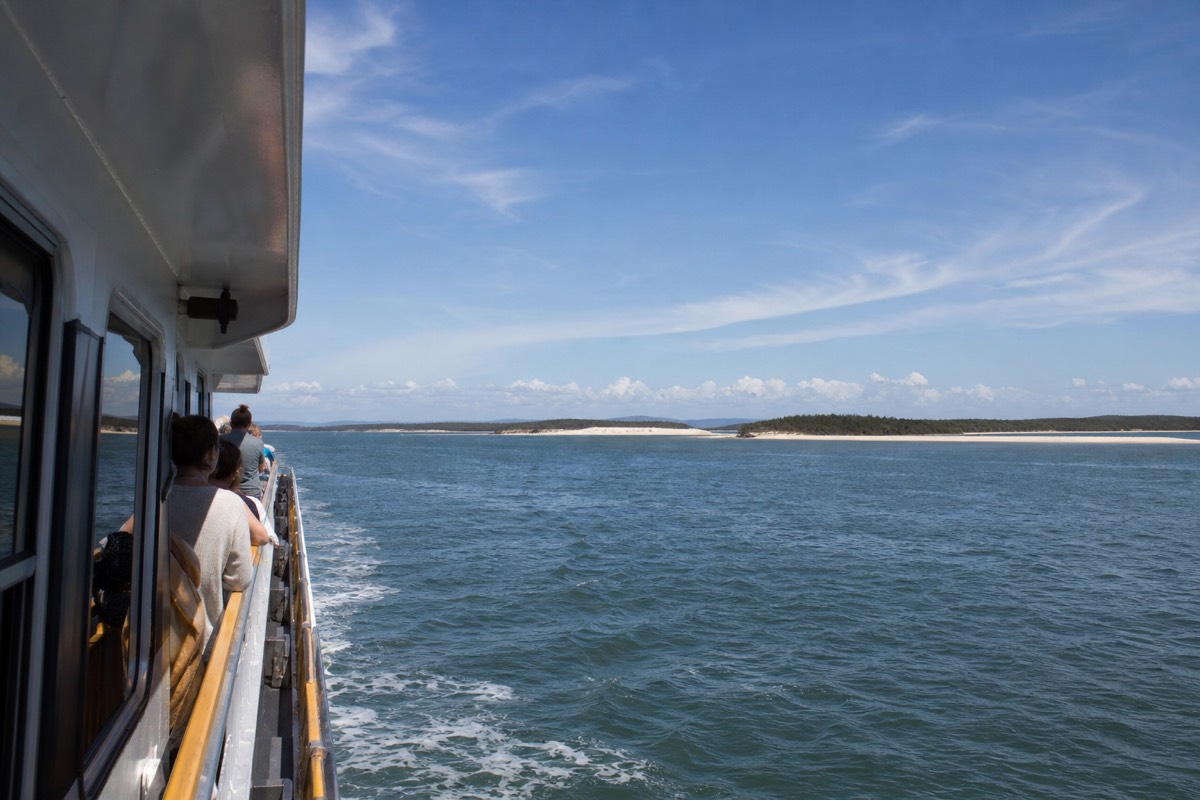 A vehicle and passenger ferry crossing Moreton Bay toward Moreton Island